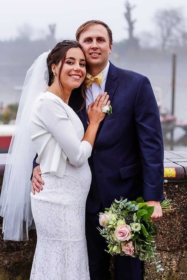Bride and groom portrait by the river